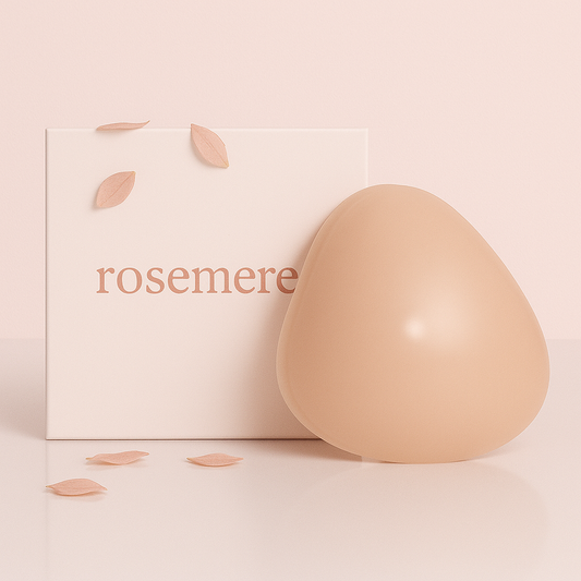 Beige breast pad next to a 'rosemere' branded box on a light pink background